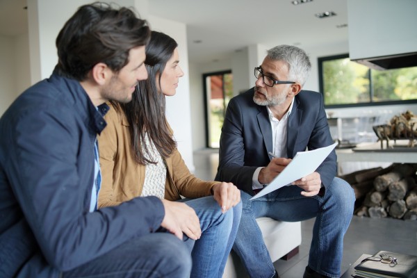middle aged couple discussing their finance goals with their wealth manager