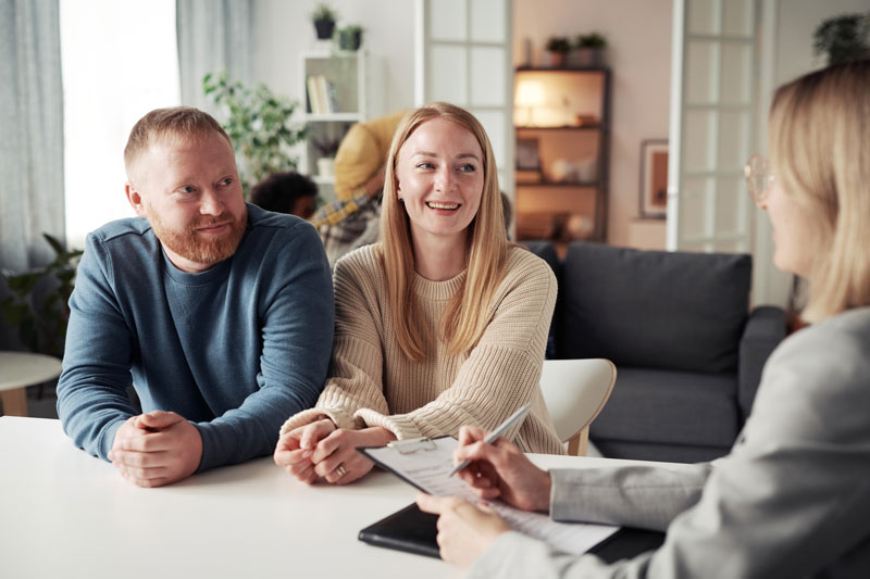 a financial advisor speaking with a newly wed couple