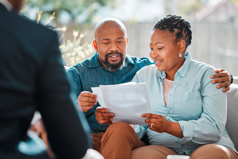 a happy couple reviewing their investment portfolio