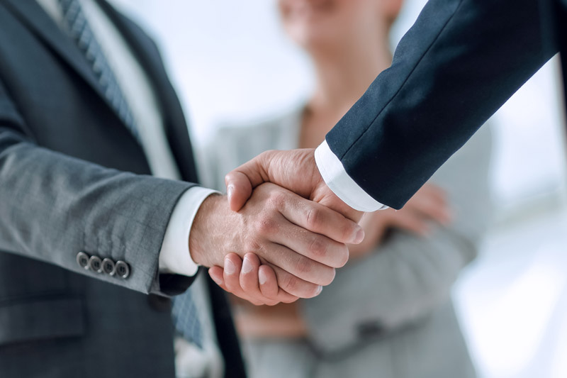 business executive shaking hands with an advisor at kirk