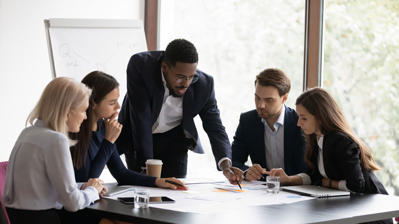 business professionals holding a meeting to discuss employee retirement plans