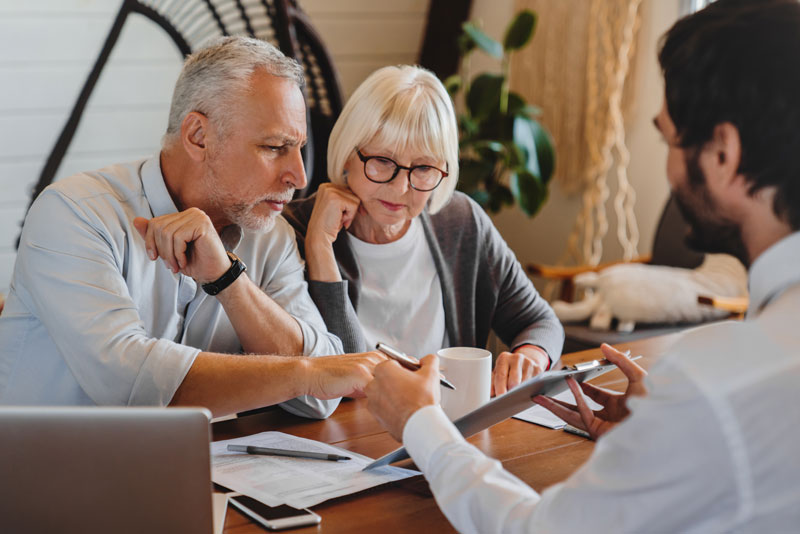 elderly couple discussing their options for retirement planning