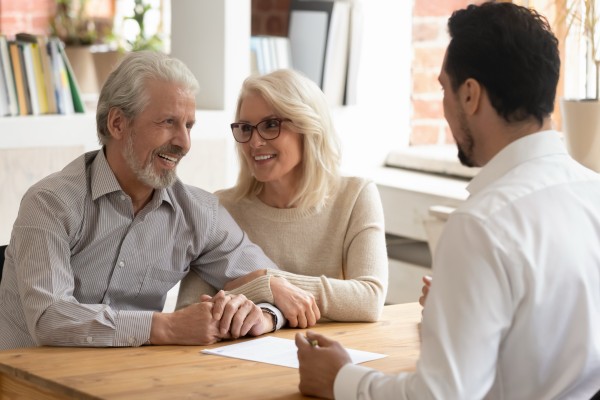elderly spouses discussing their estate planning for next quarter with their finance advisor at kirk capital