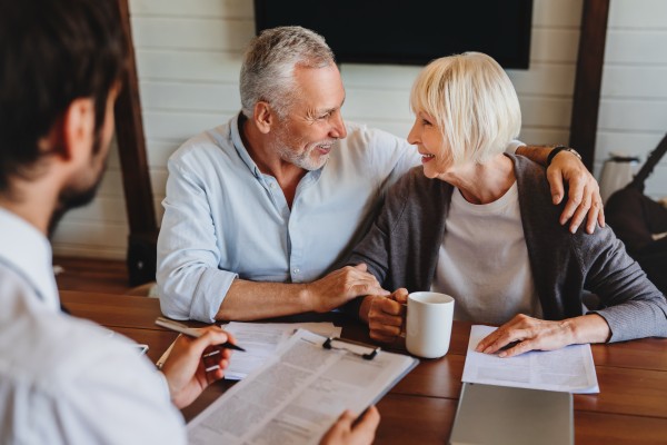 married couple reviewing their income distribution plan with their finance officer at kirk capital