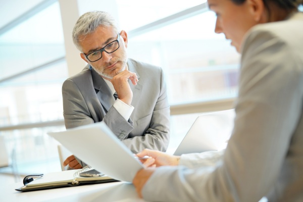 senior executive discussing their exit strategy with a financial advisor