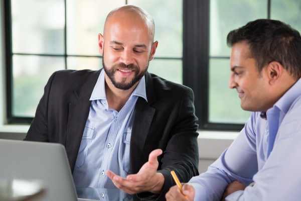 wealth management team discussing potential tax scenarios with a client