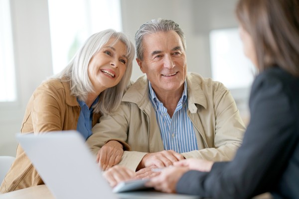 elderly couple discussing their gifting and legacy needs with their financial advisor