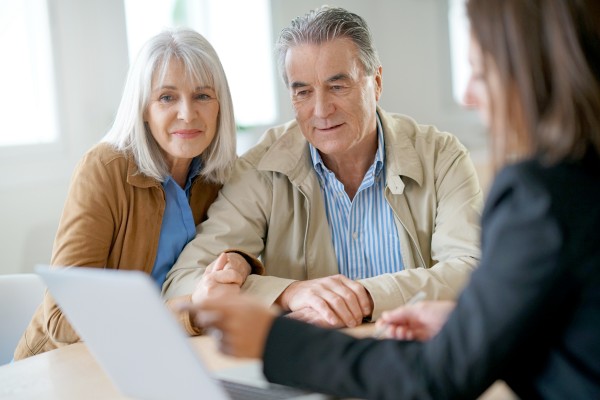 elderly couple meeting with their financial advisor