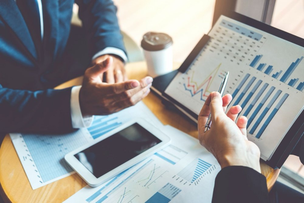 investors reviewing reports on their investments