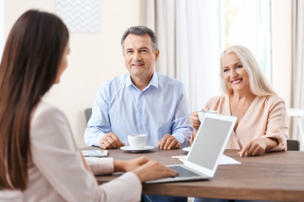 mature wealthy couple meeting with their investment manager at kirk capital advisors