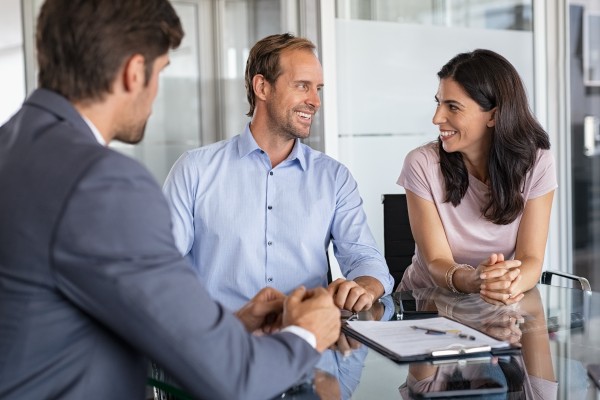 middle aged couple discussing their financial goals with their estate planning advisor