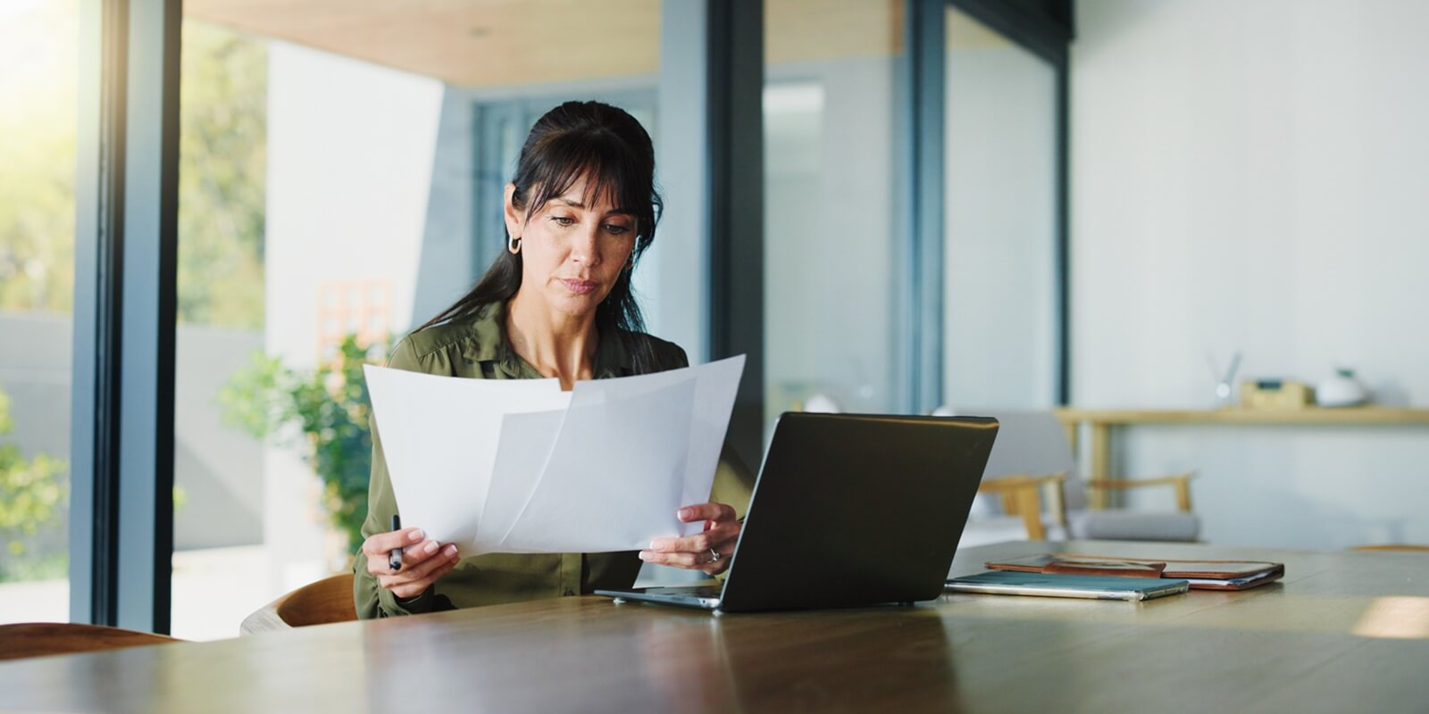 woman and document with laptop at house for real estate, property report and contract